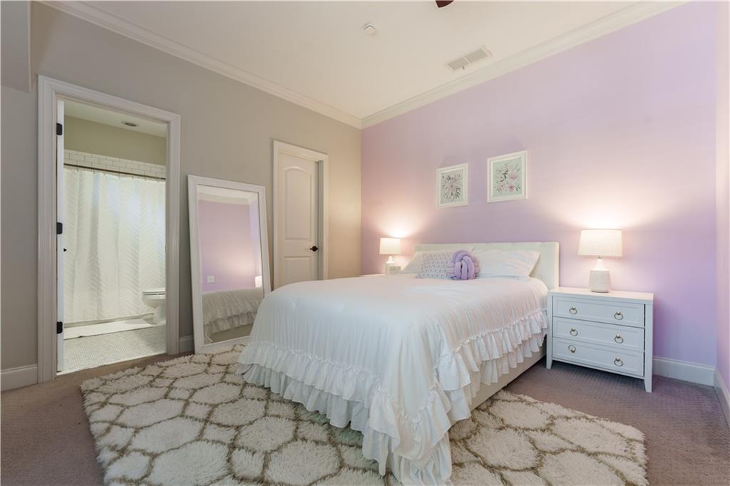 999 Ferncliff Road Northeast Atlanta, GA 30324 - Photo 33 of 52 a bedroom with a bed and a lamp