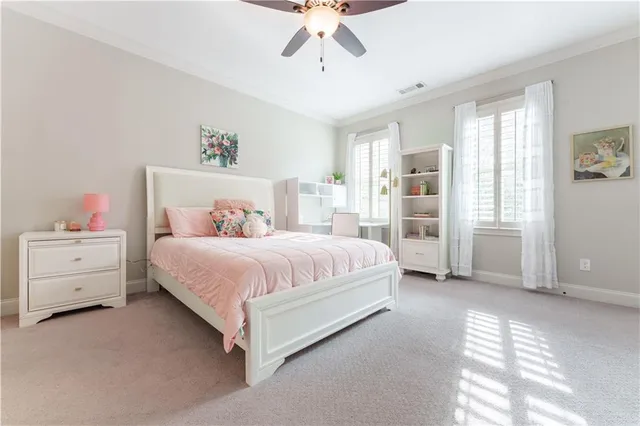 a spacious bedroom with a bed and a window