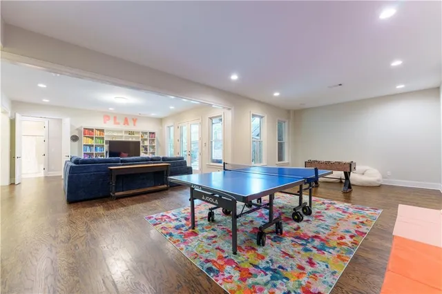 a living room with furniture and a dining table with wooden floor