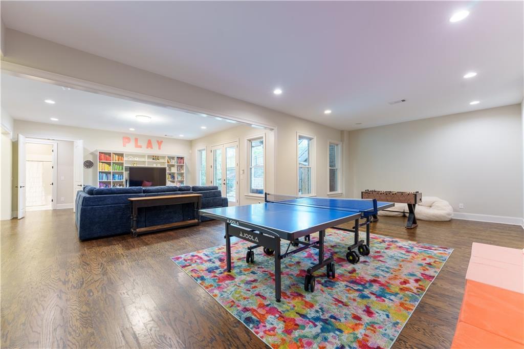 999 Ferncliff Road Northeast Atlanta, GA 30324 - Photo 40 of 52 a living room with furniture and a dining table with wooden floor