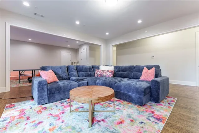 a living room with furniture and a wooden floor
