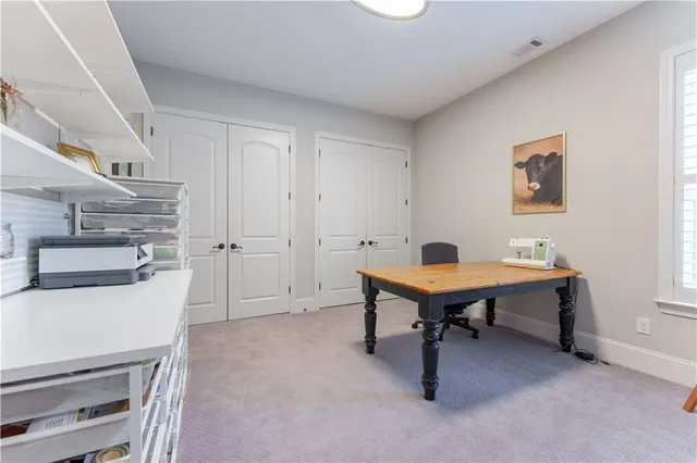 a front view of a house with a yard and trees