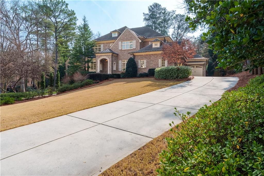 999 Ferncliff Road Northeast Atlanta, GA 30324 - Photo 47 of 52 a front view of a house with a yard and trees