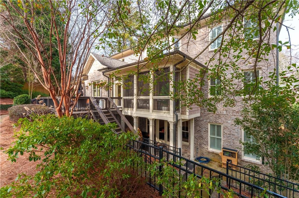 999 Ferncliff Road Northeast Atlanta, GA 30324 - Photo 6 of 52 a view of a brick house with large windows and a large tree