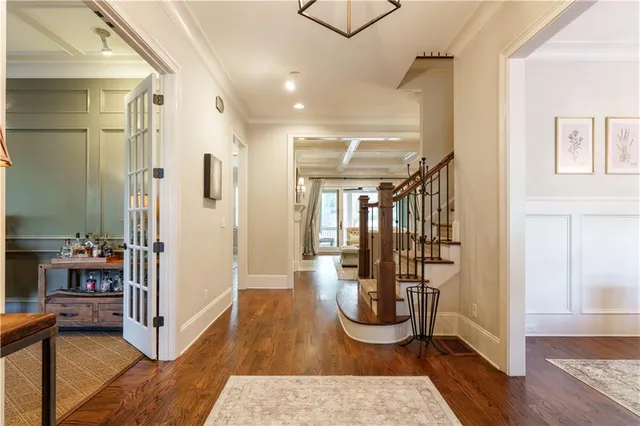 a view of a hallway with wooden floor and furniture