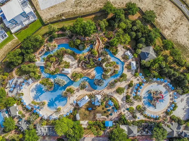 an aerial view of a house with garden space and lake view