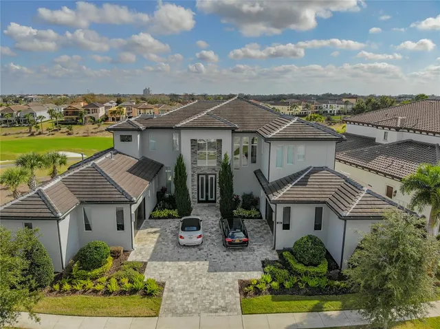 an aerial view of a house with outdoor space basket ball court and outdoor seating