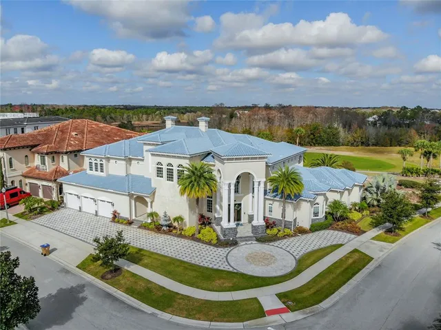 an aerial view of residential houses with outdoor space and swimming pool