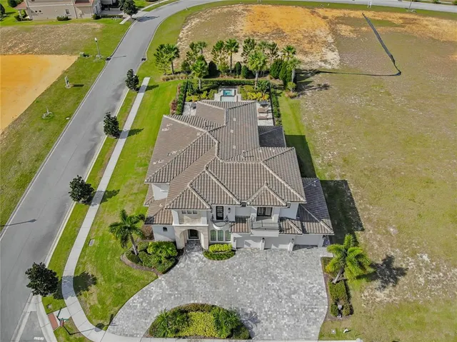 an aerial view of residential houses with outdoor space and river