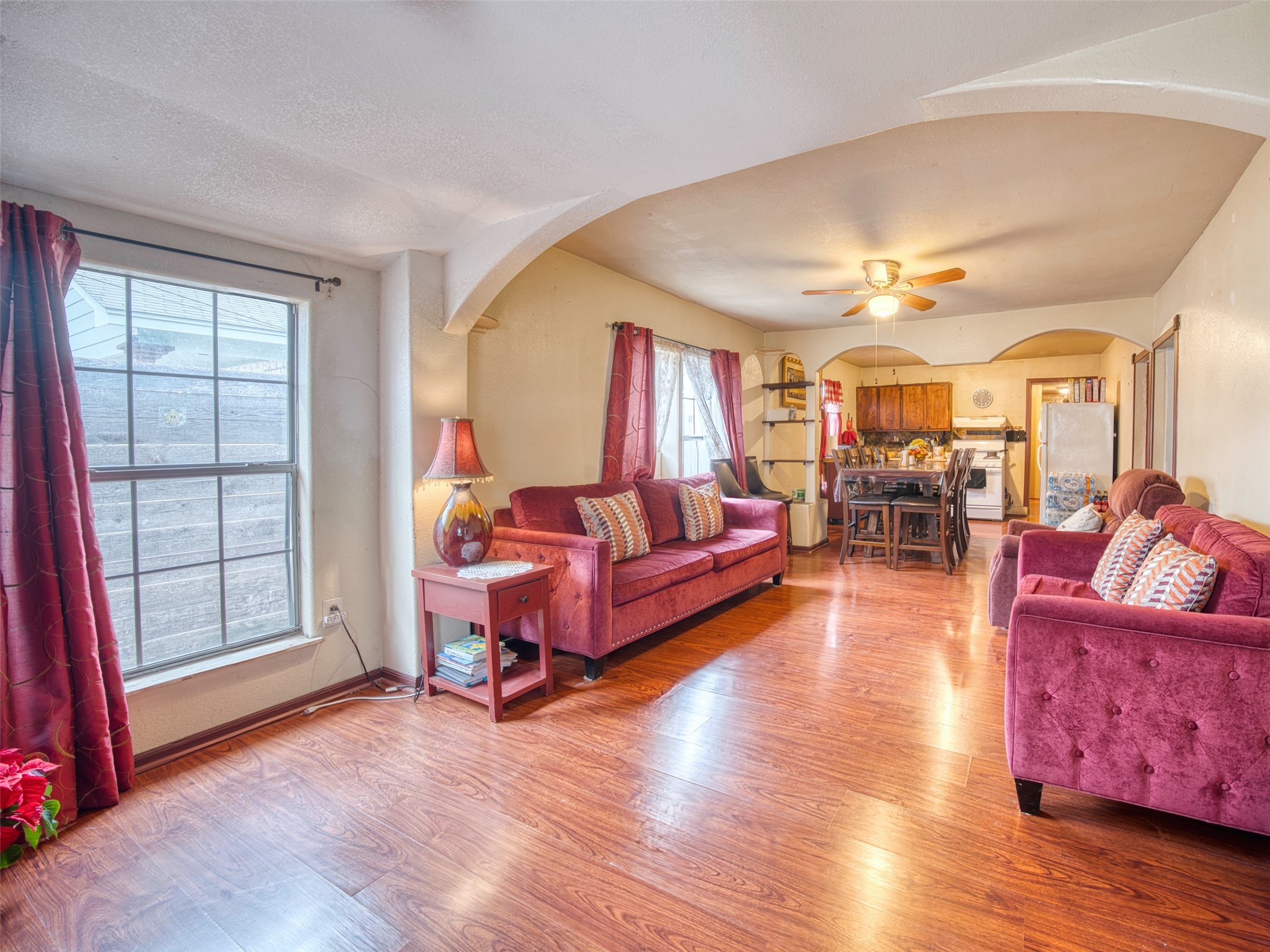 Living room featuring ceiling fan and wood-style floors