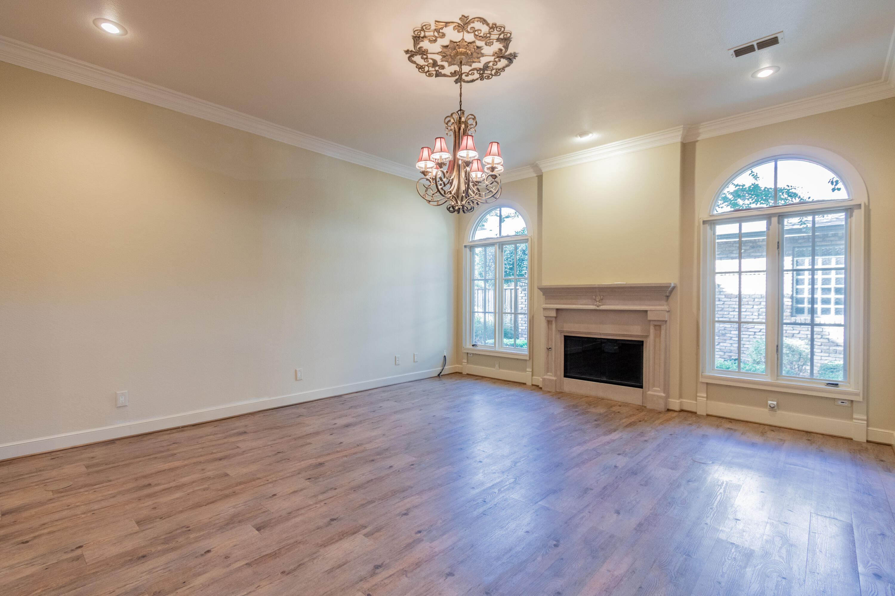 4501 19th Street, Unit 5 Lubbock, TX 79407 - Photo 11 of 52 wooden floor in an empty room with a fireplace