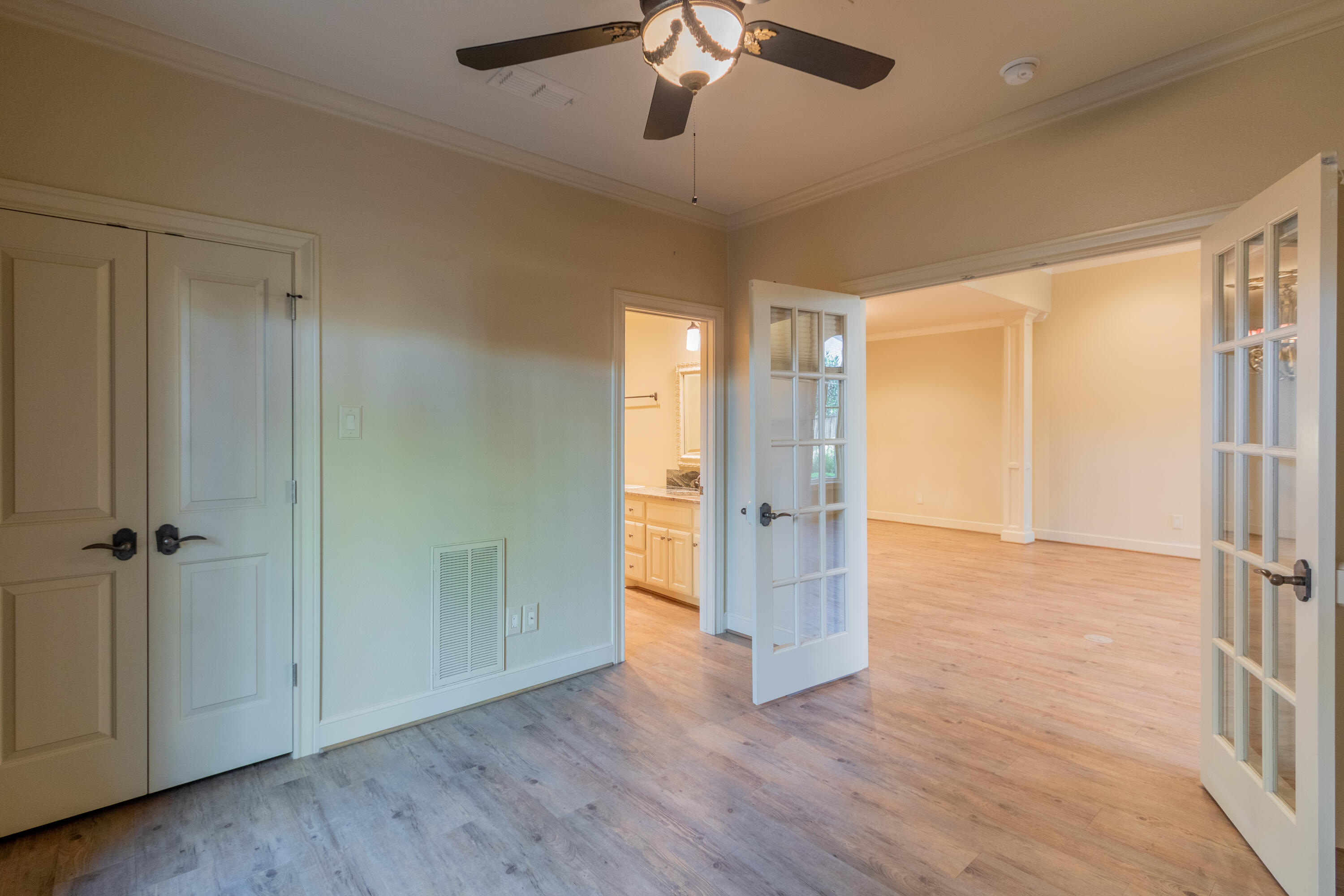4501 19th Street, Unit 5 Lubbock, TX 79407 - Photo 15 of 52 an empty room with wooden floor cabinet and windows