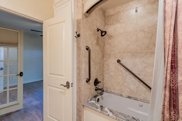 a bathroom with a bathtub and a shower