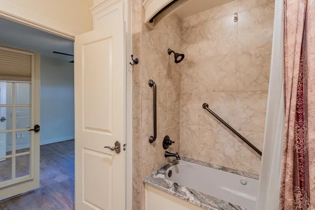 a bathroom with a bathtub and a shower