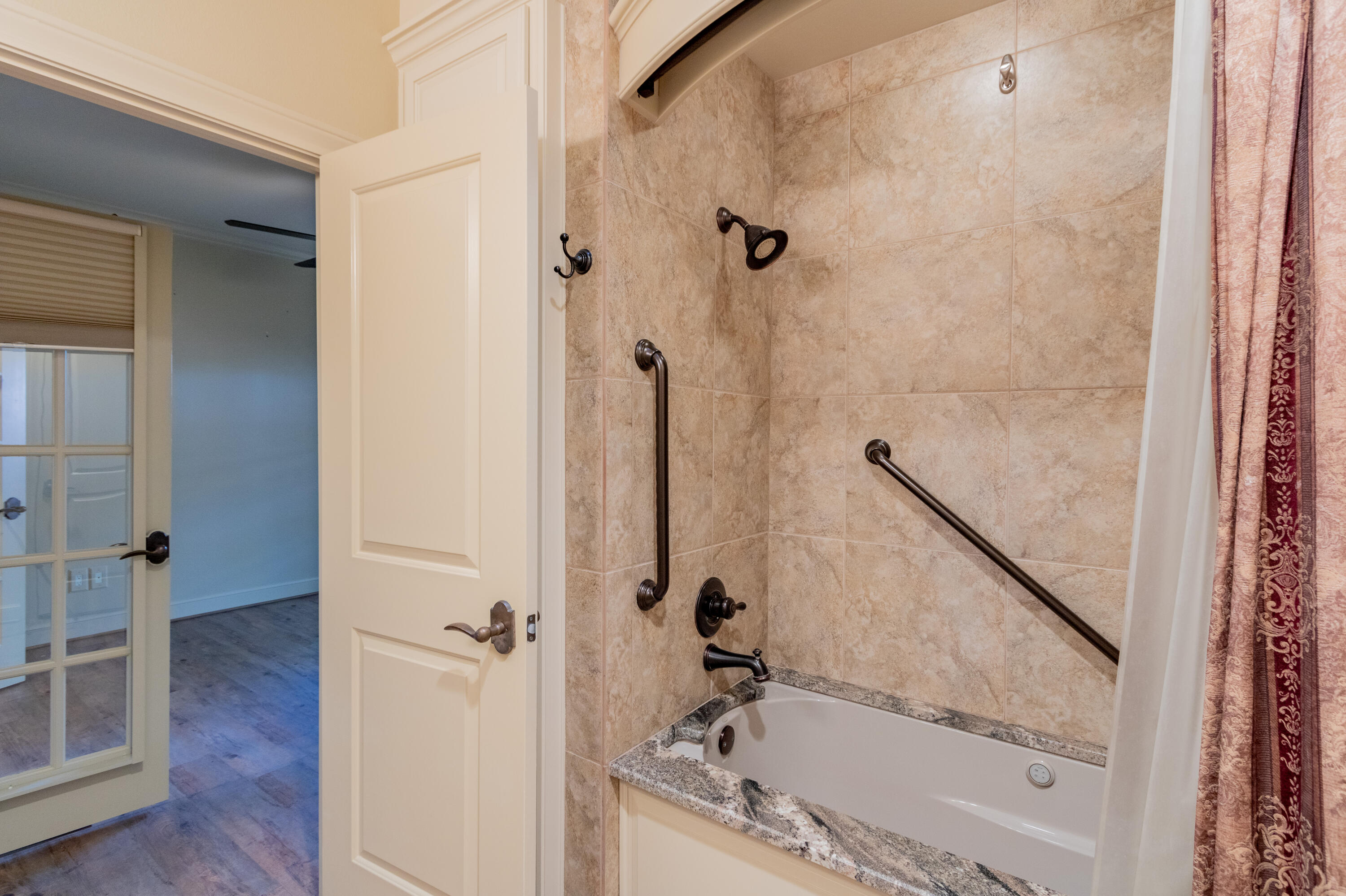 4501 19th Street, Unit 5 Lubbock, TX 79407 - Photo 17 of 52 a bathroom with a bathtub and a shower