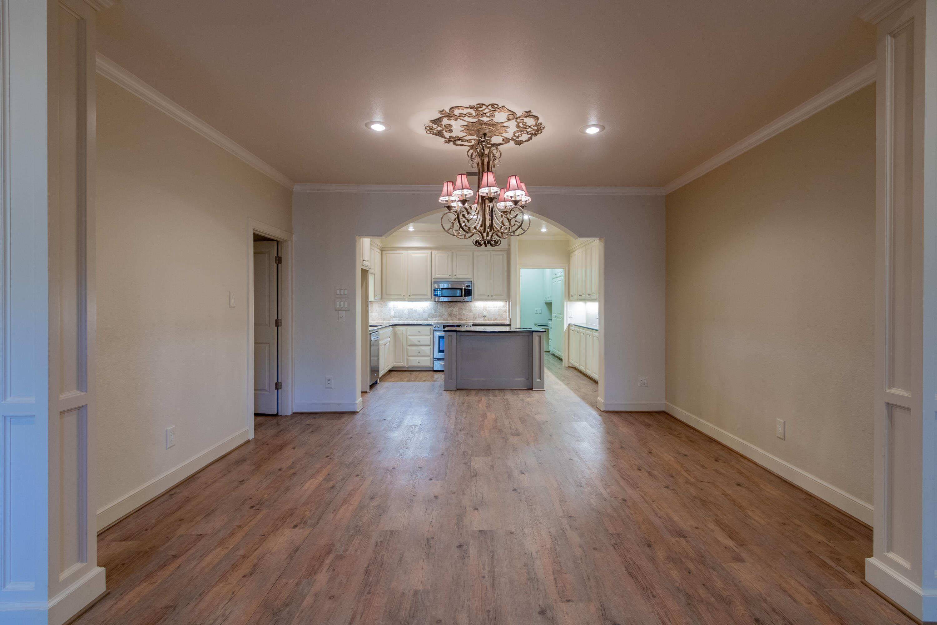 4501 19th Street, Unit 5 Lubbock, TX 79407 - Photo 18 of 52 a view of a dining room with furniture wooden floor and chandelier
