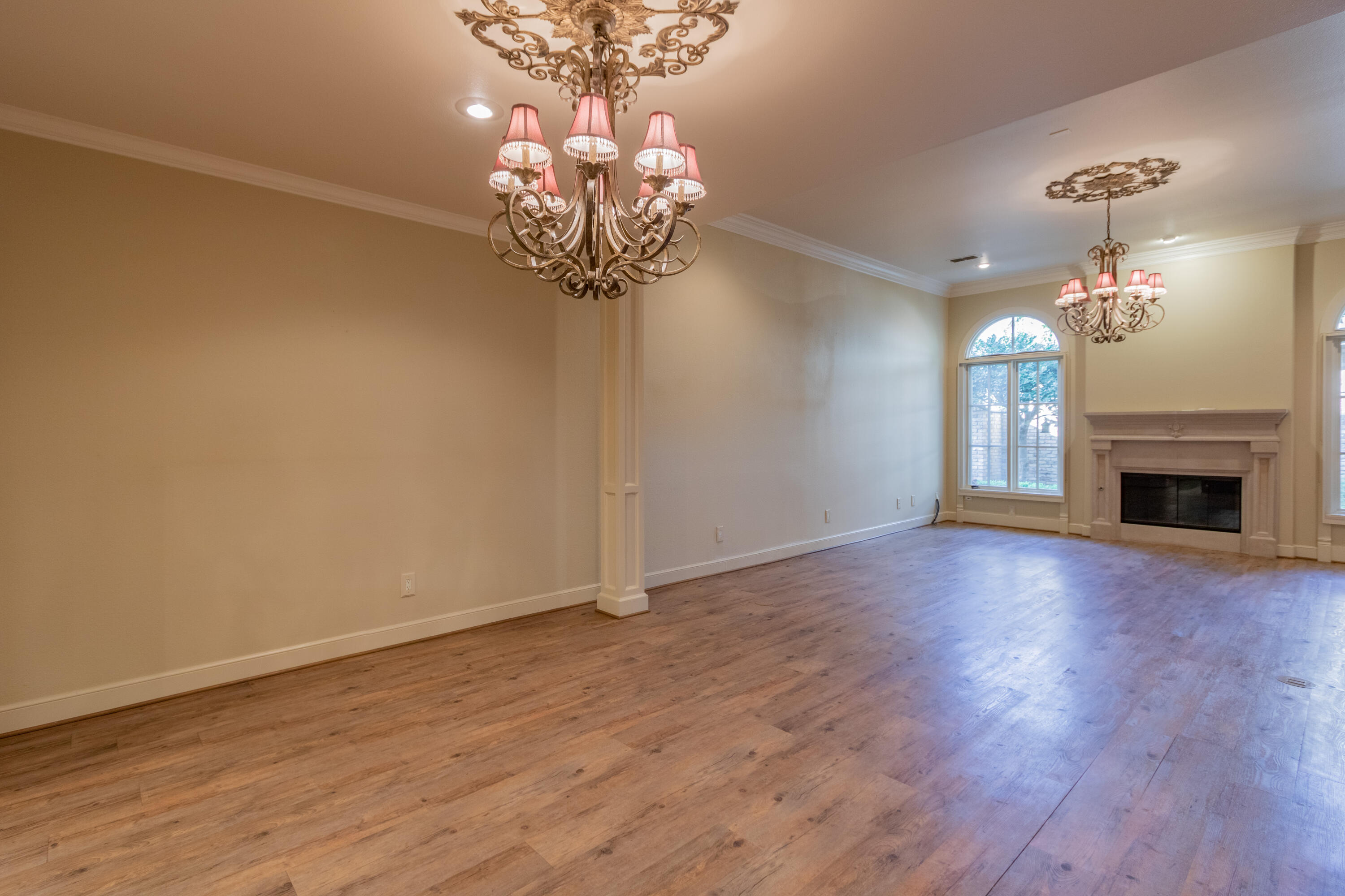 4501 19th Street, Unit 5 Lubbock, TX 79407 - Photo 20 of 52 a view of a room with wooden floor and chandelier