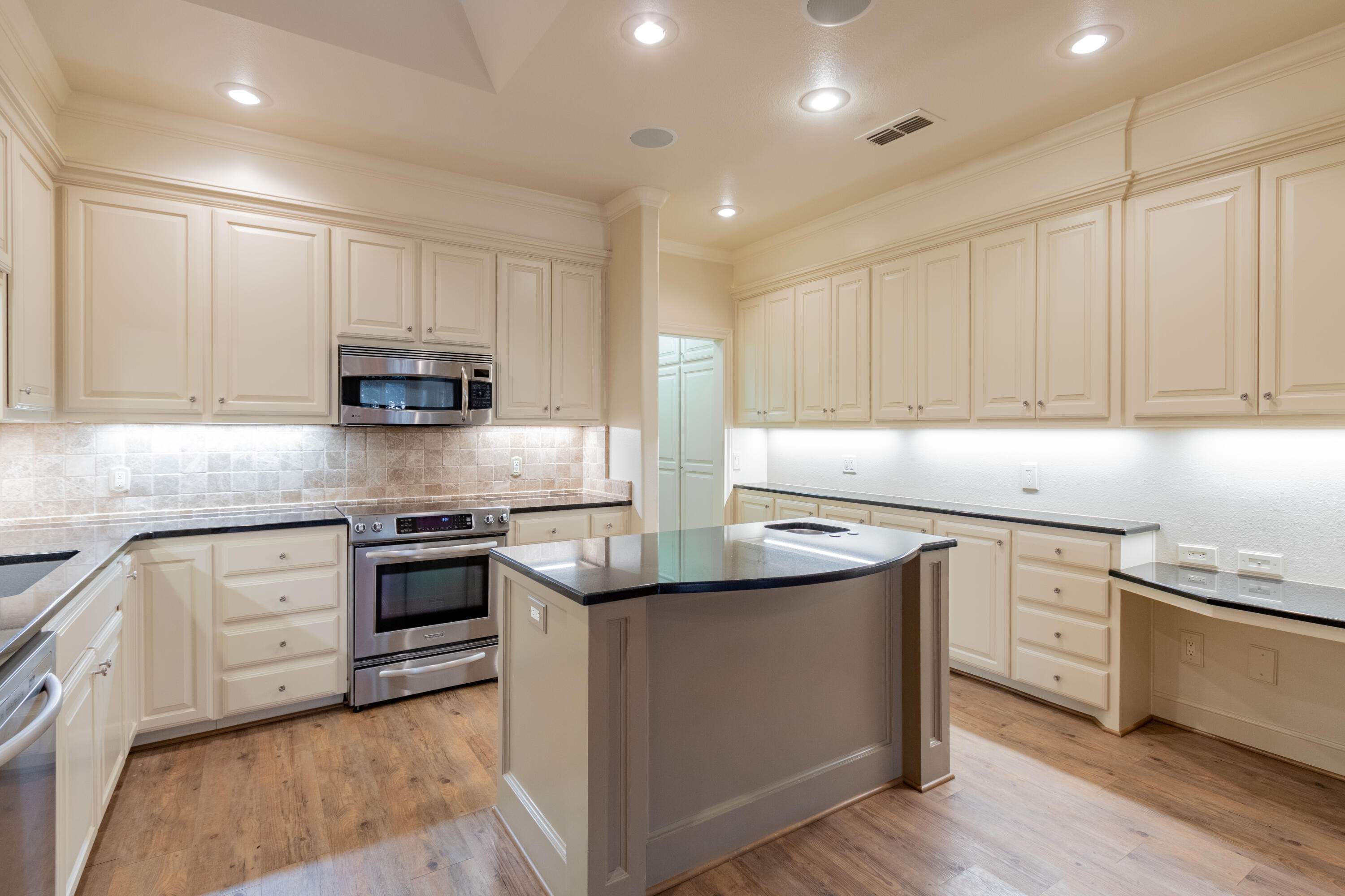 4501 19th Street, Unit 5 Lubbock, TX 79407 - Photo 23 of 52 a kitchen with stainless steel appliances granite countertop a sink stove and cabinets
