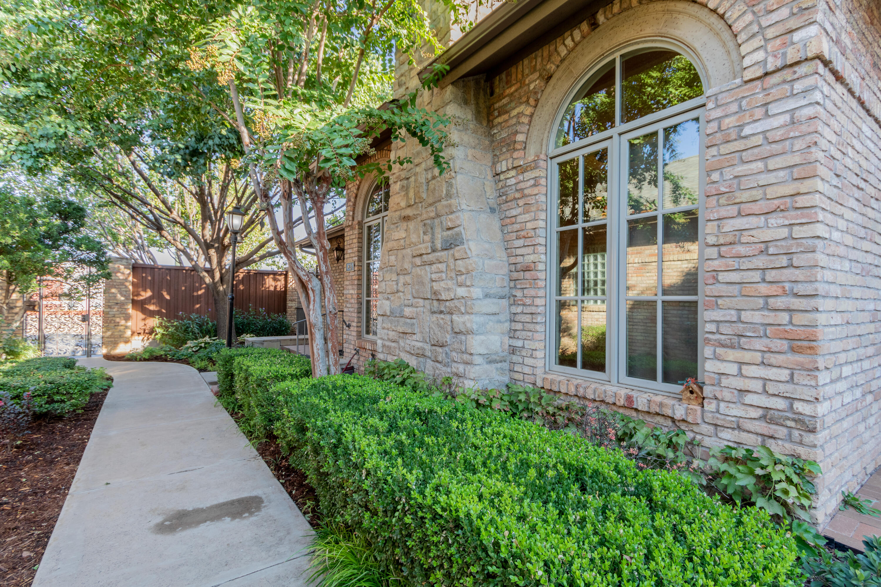 4501 19th Street, Unit 5 Lubbock, TX 79407 - Photo 3 of 52 front view of a house with a garden