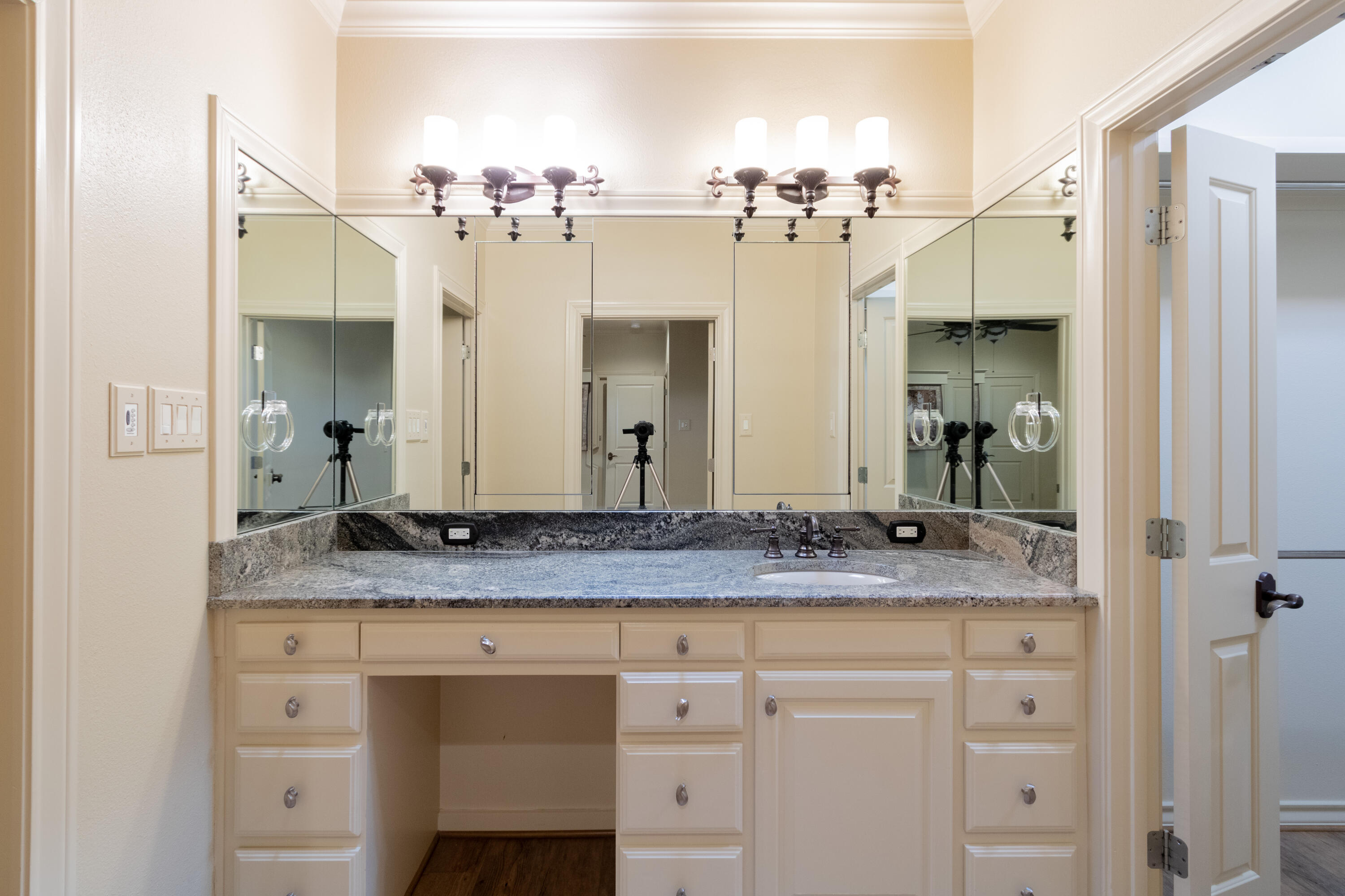 4501 19th Street, Unit 5 Lubbock, TX 79407 - Photo 33 of 52 a bathroom with a granite countertop sink and a mirror
