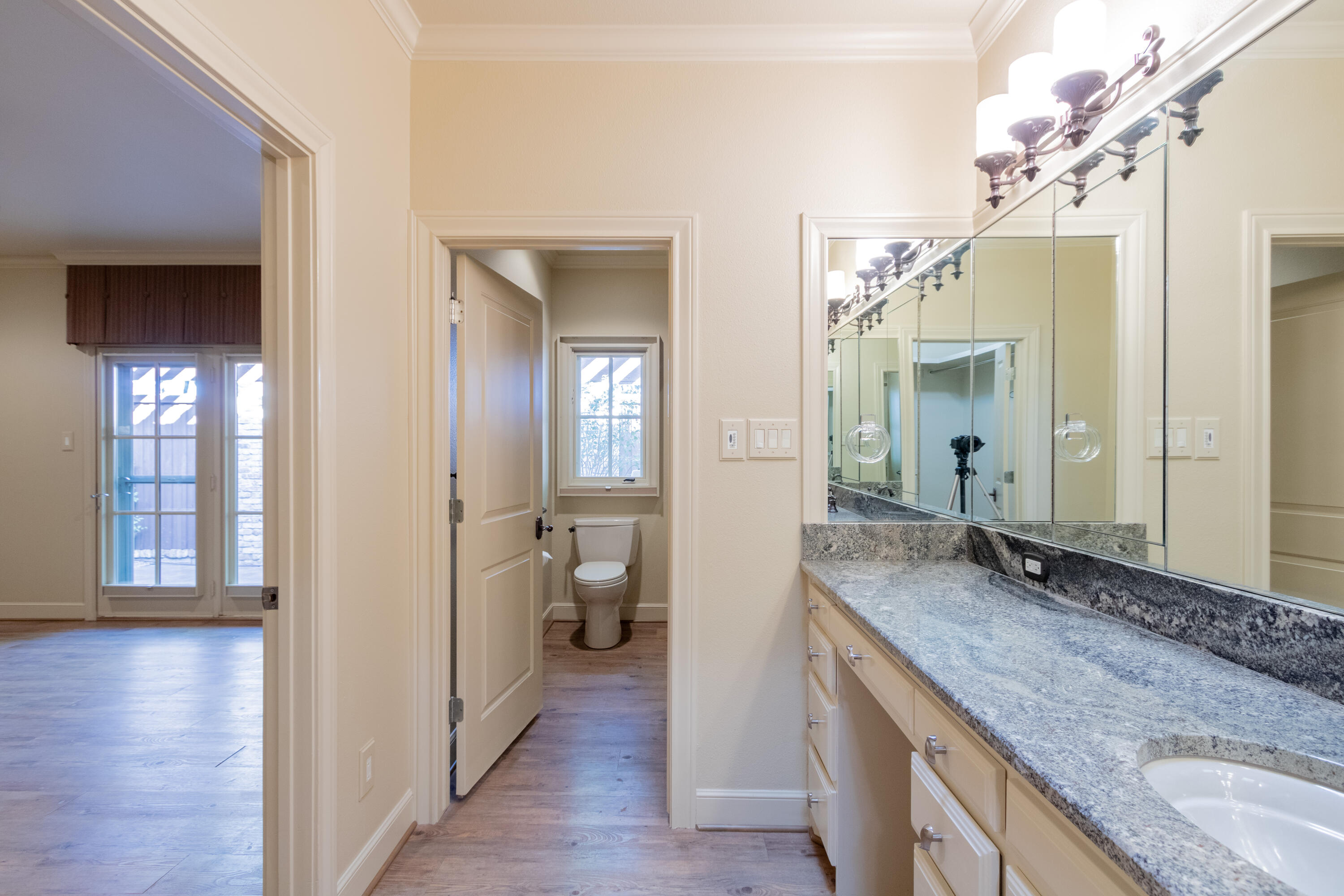4501 19th Street, Unit 5 Lubbock, TX 79407 - Photo 34 of 52 a spacious bathroom with a granite countertop sink and a mirror