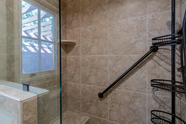 a spacious bathroom with a granite countertop sink mirror and a shower