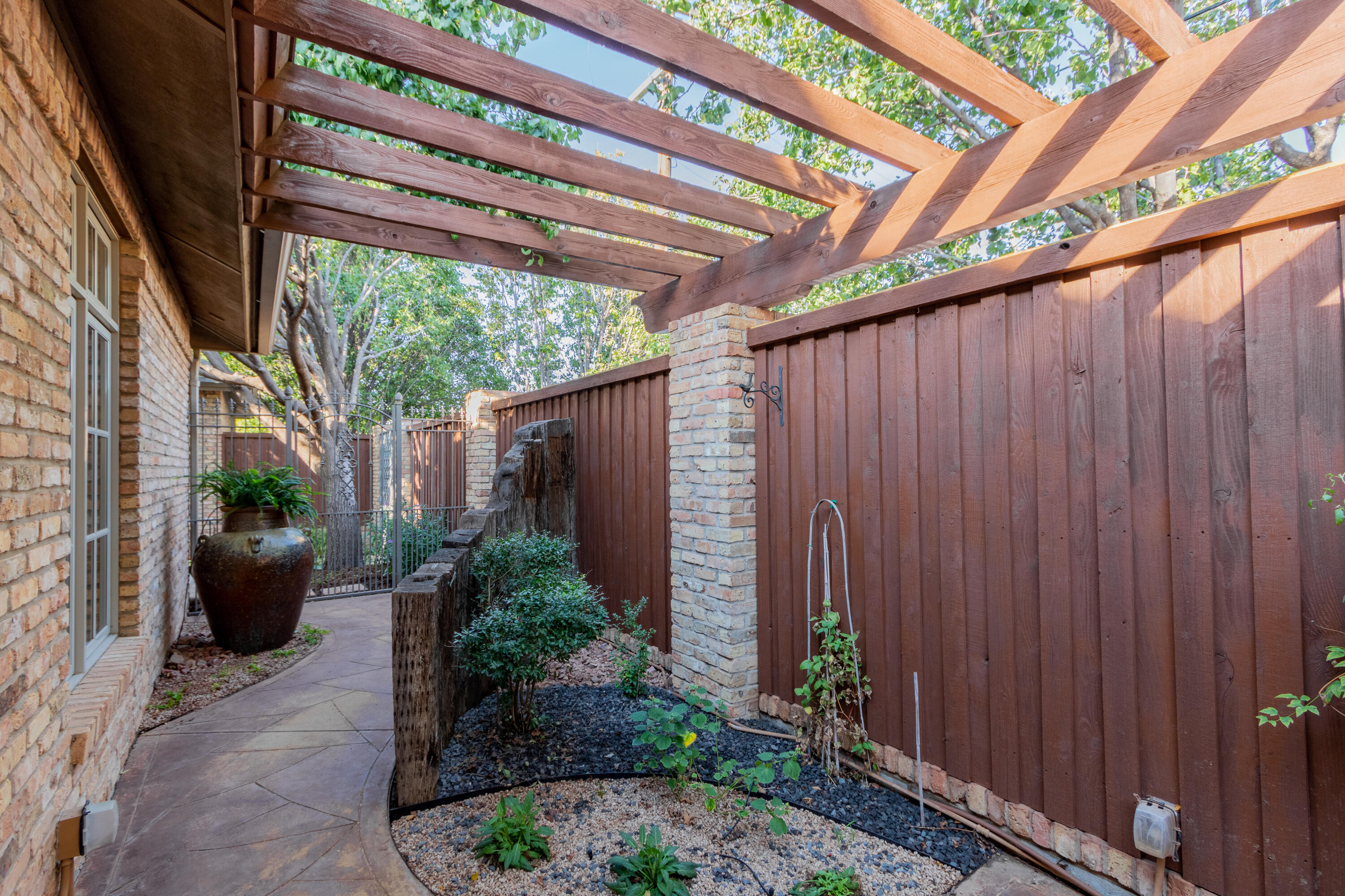 4501 19th Street, Unit 5 Lubbock, TX 79407 - Photo 38 of 52 a couple of potted plants in front of door