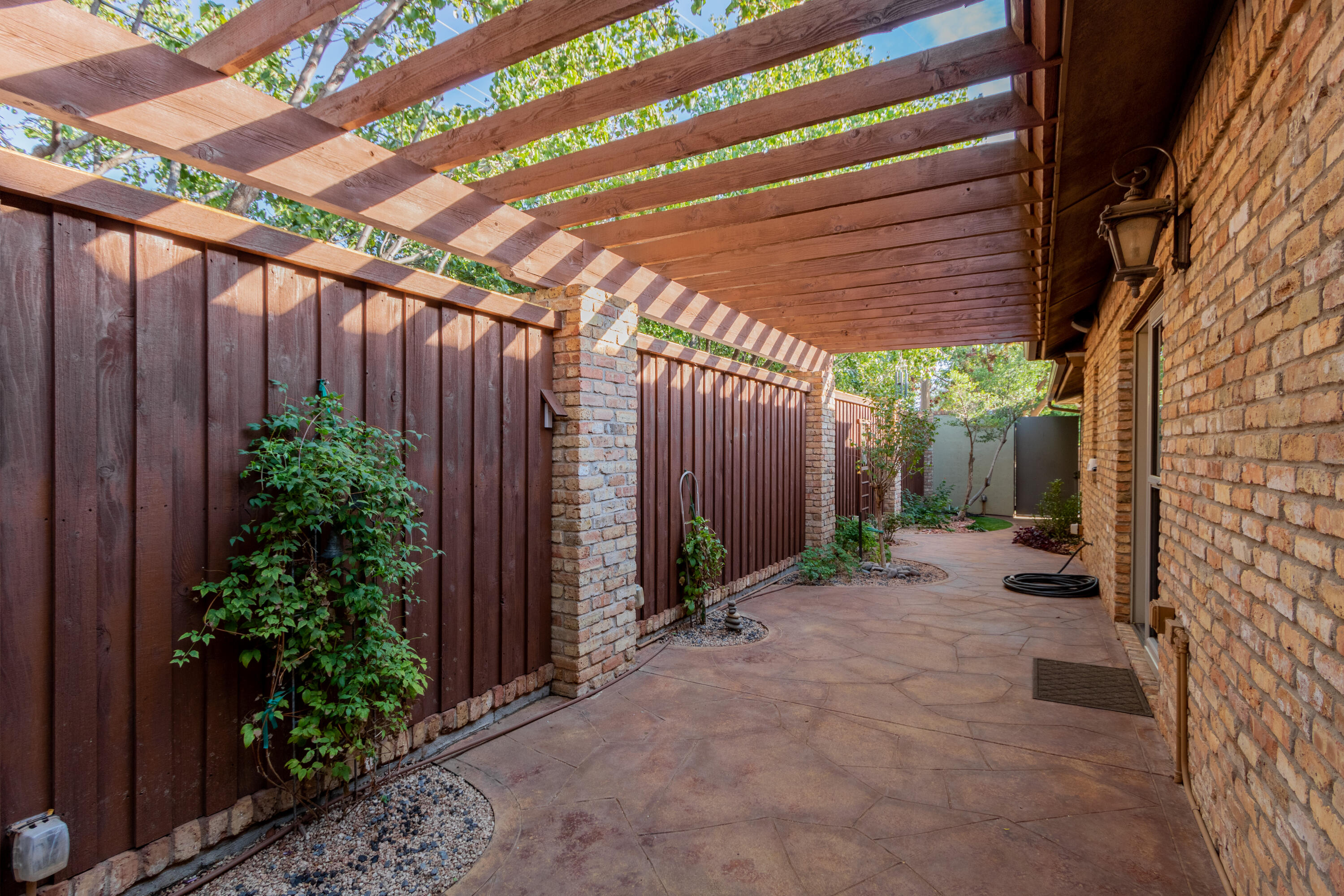 4501 19th Street, Unit 5 Lubbock, TX 79407 - Photo 41 of 52 a view of a backyard with plants and wooden fence