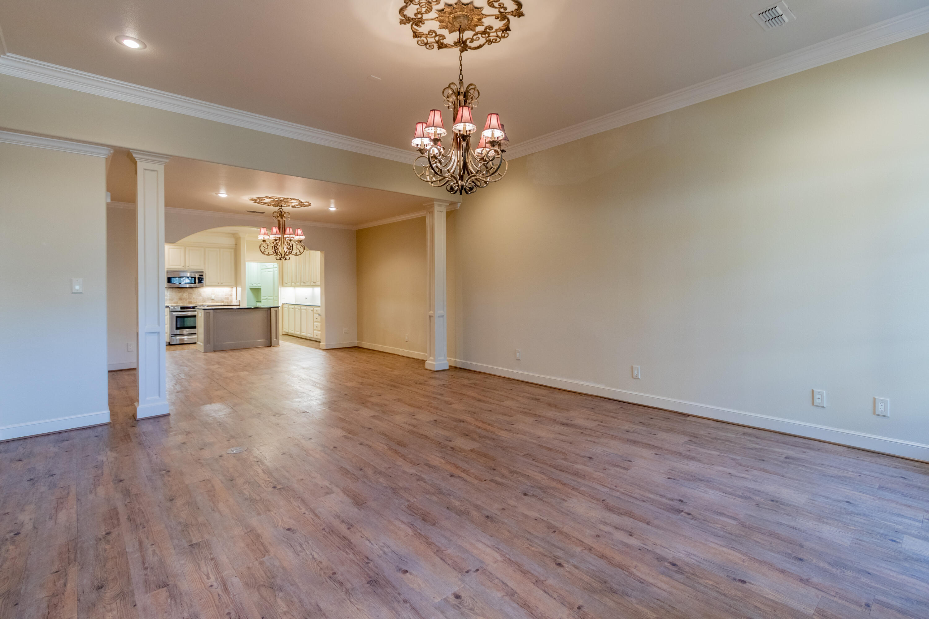 4501 19th Street, Unit 5 Lubbock, TX 79407 - Photo 8 of 52 a view of a big room with wooden floor chandelier and windows