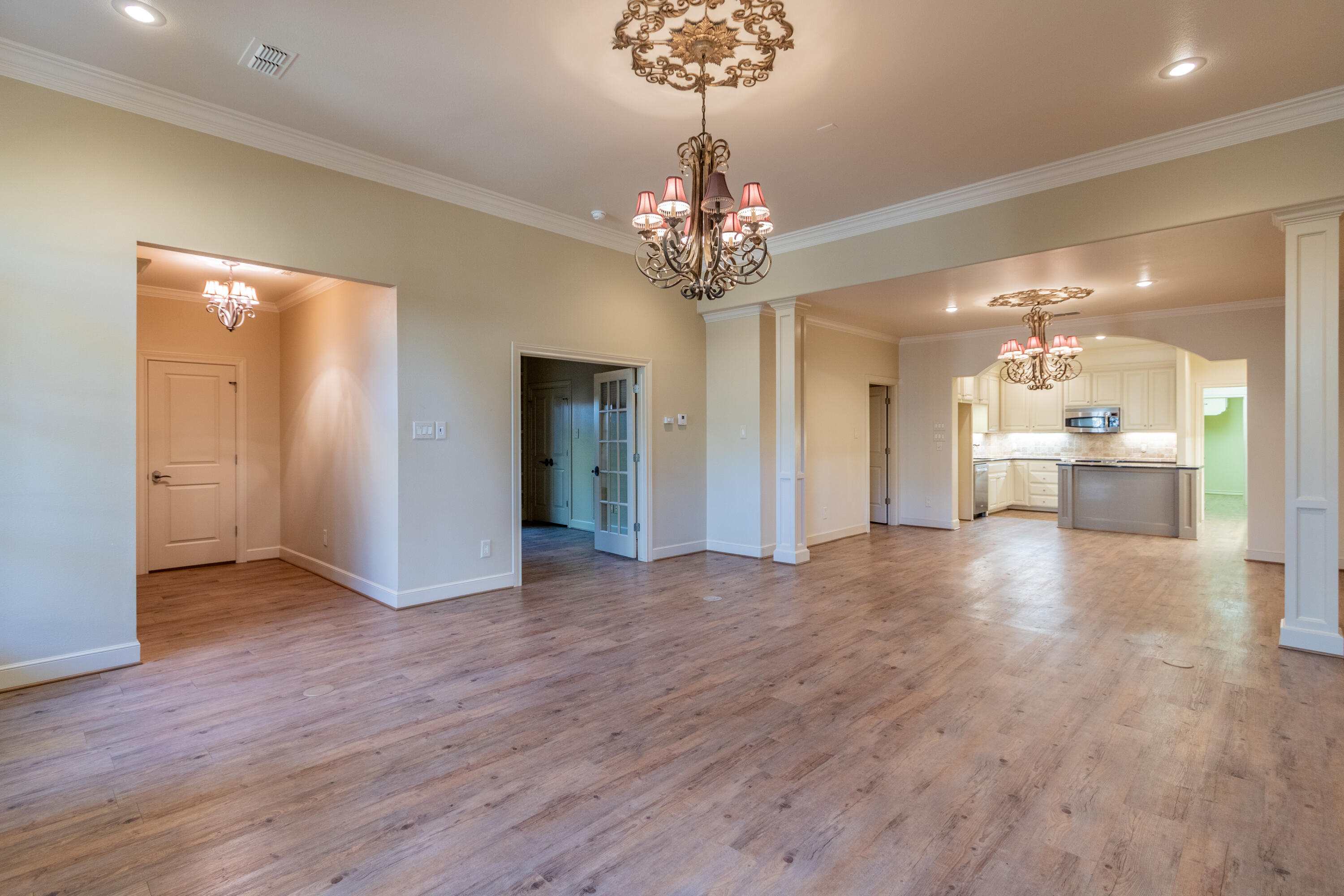 4501 19th Street, Unit 5 Lubbock, TX 79407 - Photo 9 of 52 a view of a hallway with wooden floor and a kitchen