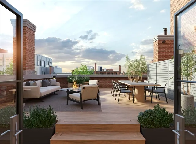 a view of a patio with couches potted plants and a table