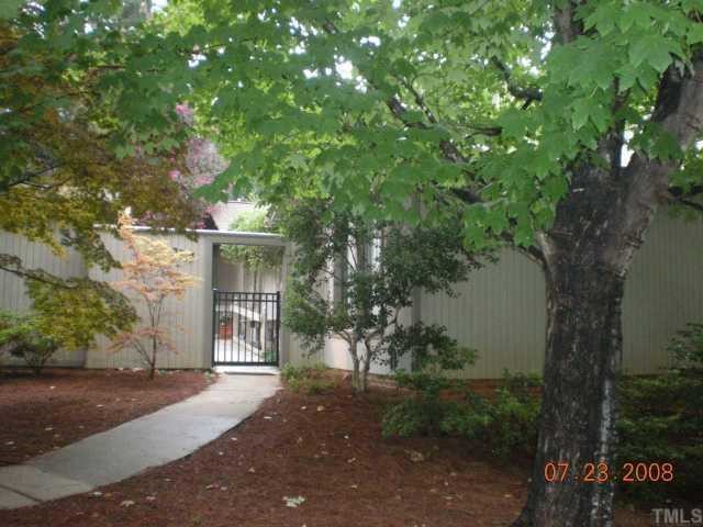 2713 Rue Sans Famille Raleigh, NC 27607 - Photo 1 of 12 a view of a house with a tree