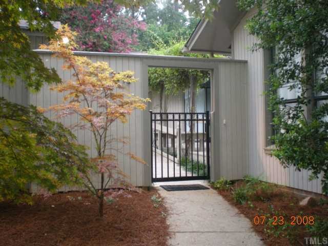 2713 Rue Sans Famille Raleigh, NC 27607 - Photo 2 of 12 a front view of a house with a yard
