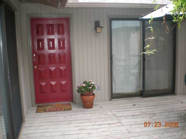 2713 Rue Sans Famille Raleigh, NC 27607 - Photo 3 of 12 a view of a door with a potted plant