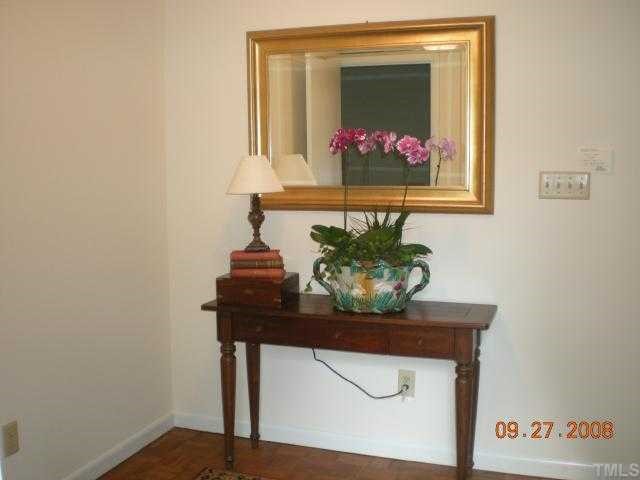 2713 Rue Sans Famille Raleigh, NC 27607 - Photo 4 of 12 a view of a hallway with a table and a vase