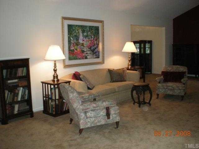 2713 Rue Sans Famille Raleigh, NC 27607 - Photo 6 of 12 a living room with furniture and a lamp