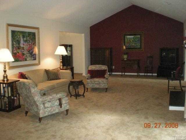 2713 Rue Sans Famille Raleigh, NC 27607 - Photo 7 of 12 a living room with furniture and a lamp