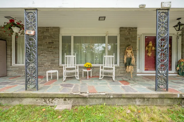 a house view with swimming pool and sitting space
