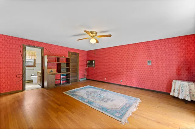 a view of a room with window and a ceiling fan