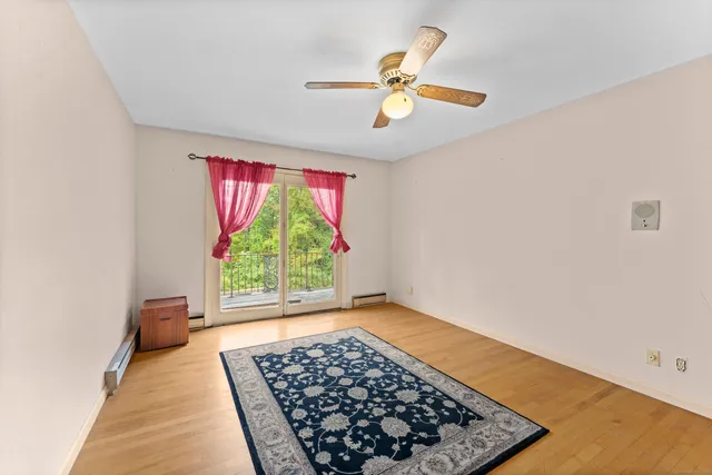 a view of a bedroom with wooden floor