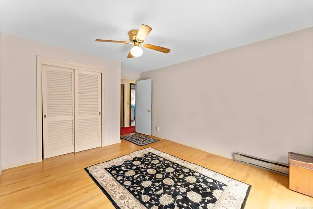 a bedroom with furniture and a large window