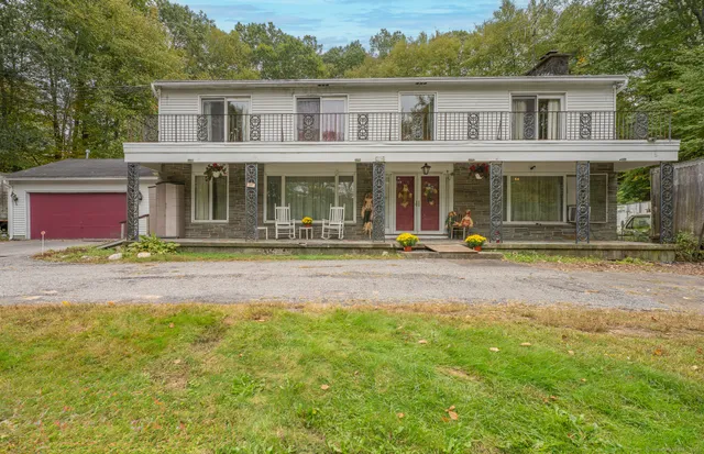 a front view of a house with garden