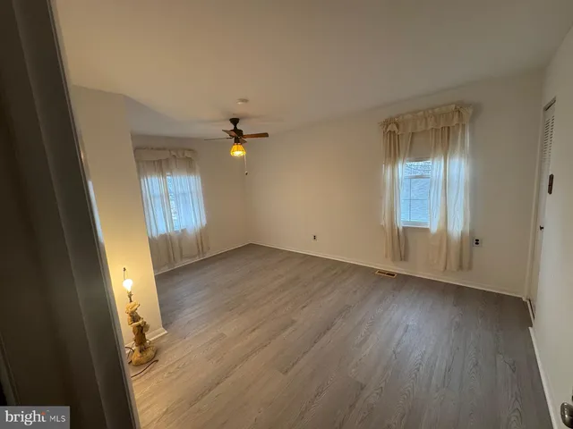 a view of a room with wooden floor
