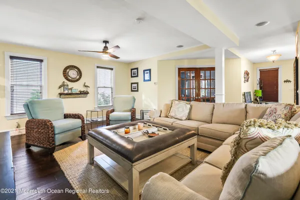 a living room with furniture and a wooden floor