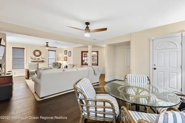 a kitchen with stainless steel appliances granite countertop a table chairs stove and wooden floor