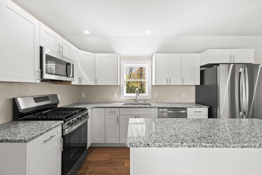146 Miller Street Middleboro, MA 02346 - Photo 16 of 23 a kitchen with stainless steel appliances granite countertop a stove a sink a microwave a refrigerator and cabinets