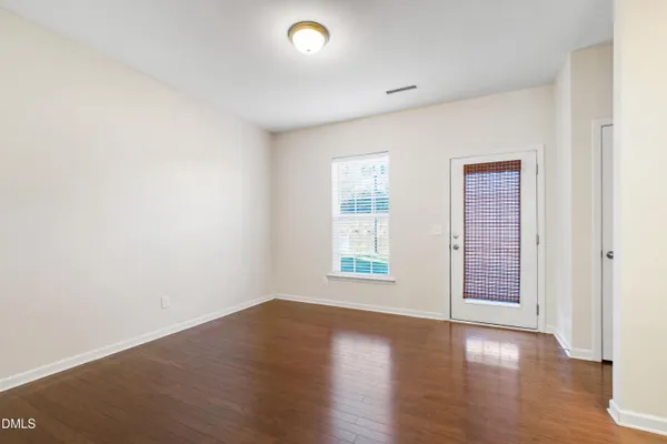 a kitchen with a sink cabinets and wooden floor