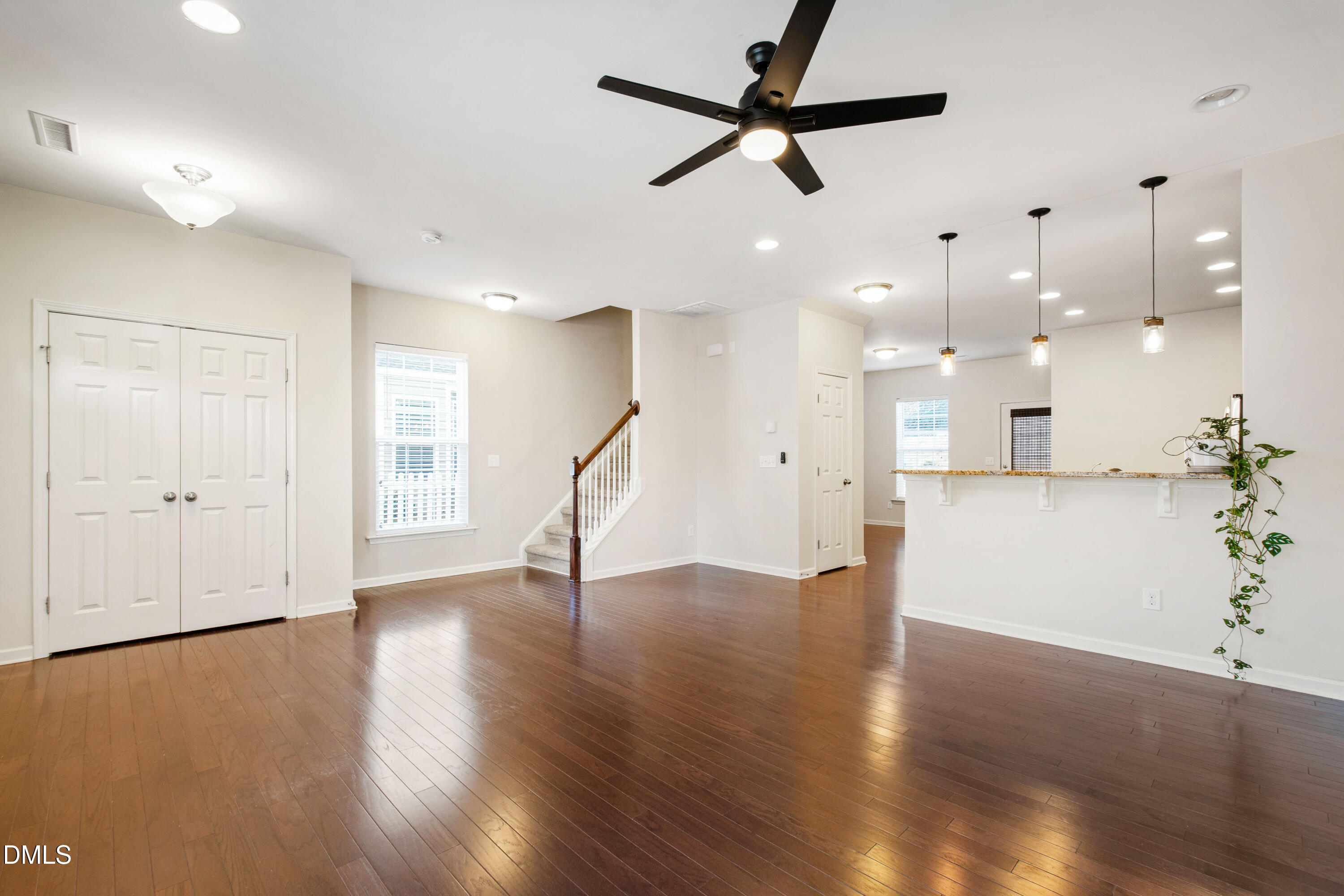 1118 Renewal Place Raleigh, NC 27603 - Photo 6 of 38 a view of an empty room with wooden floor and a ceiling fan
