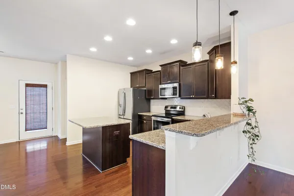 a kitchen with wooden cabinets and white appliances