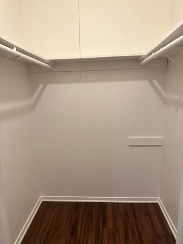 a white toilet sitting next to a shower